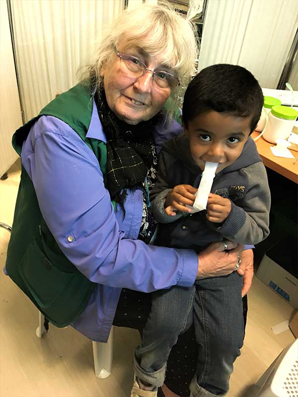 Valerie with young refugee boy