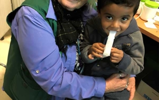 Valerie with young refugee boy